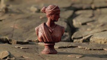 ancient statue of woman on rocky stones