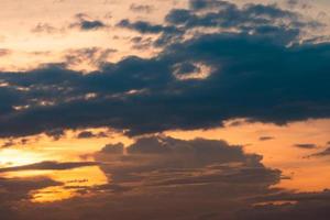 Sunset sky. Heaven sky. Orange sky with soft white fluffy cloud. Sunlight at dusk. Beauty in nature. Beautiful natural pattern layer of clouds in the evening. Dusk and dawn times abstract background. photo