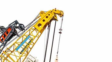 Big yellow construction crane for heavy lifting isolated on white background. Construction industry. crane for container lift or at construction site. Crane rental business concept. Crane dealership. photo
