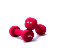 Set of red dumbbells isolated on white background. A pair of red neoprene dumbbells. Home gym equipment for exercise at home. Weight training equipment for sculpt arms, shoulders, back, and legs. photo