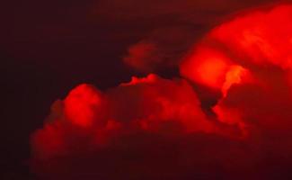 Red clouds with dark sunset sky. Red bloody clouds on dark sky. Evening twilight sky. Nature background for summer season. Dramatic red sky. Hell or heaven background. Beauty and magic in nature. photo