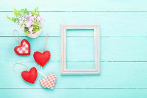 Valentine's accessories with heart shapes on blue wooden table. Top view. Mock up for text. photo