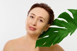 Beauty wrinkle middle age woman face portrait. Spa and anti aging concept Isolated on white background. Plastic surgery and collagen face injections. Wrinkles and menopause. Copy space photo