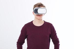 Young Man wearing virtual reality goggles isolated on white background. VR concept and copy space. photo