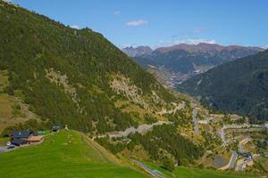 View of a curvy road in the mountain and a beautiful landscape during a sunny spring day in Andorra