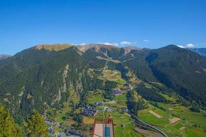 Aerial View of Canillo town and nature mountains landscape from Roc del Quer observation deck during a sunny spring day in Andorra photo