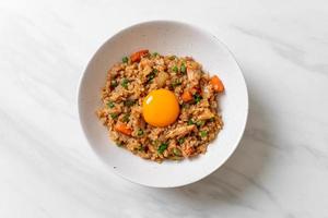 salmon fried rice with pickled egg on top photo