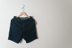 short pants hanging on wall photo