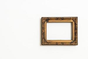 empty picture frame on white wall background photo