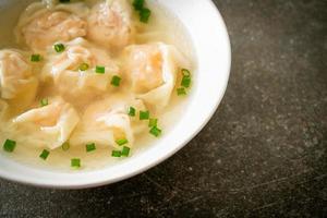 shrimp dumpling soup in white bowl photo