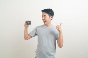 young Asian man holding credit card photo