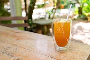 iced lemon tea in glass on wood table photo