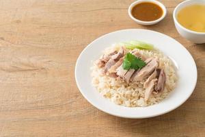 Hainanese Chicken Rice or steamed rice with chicken photo