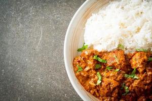 chicken tikka masala with rice on plate photo