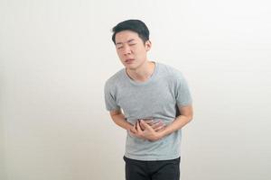 young Asian man having stomach ache photo