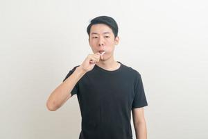 portrait young Asian man brush teeth photo