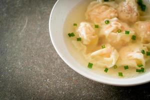 shrimp dumpling soup in white bowl photo