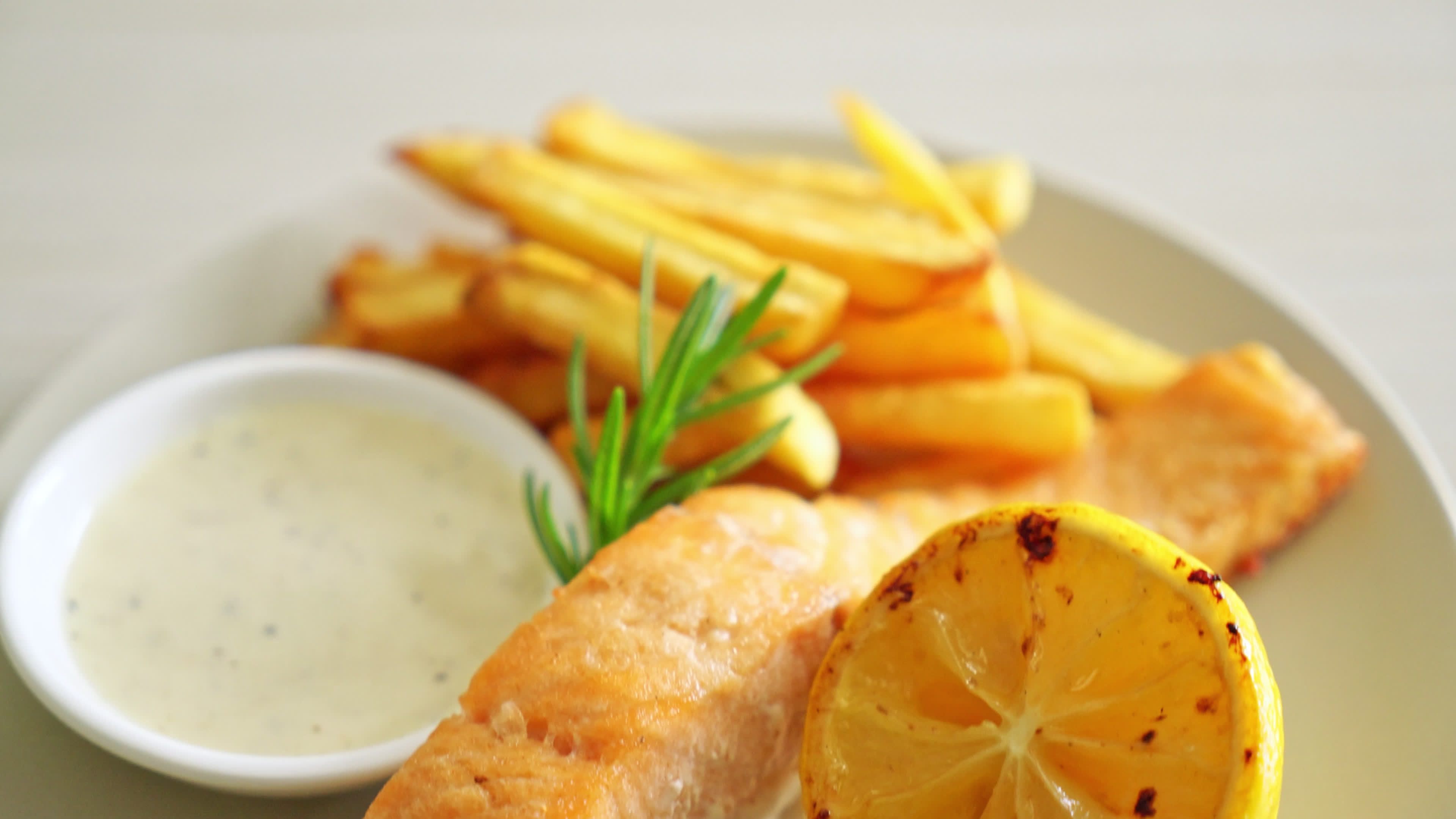 fried salmon fish and chips with lemon on plate 7671127 Stock Video at Vecteezy