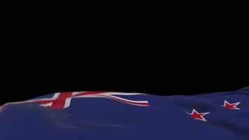 bandeira de tecido da nova zelândia acenando no loop de vento. Nova Zelândia bordado bandeira de pano costurada balançando na brisa. fundo preto meio preenchido. lugar para texto. Ciclo de 20 segundos. 4k video