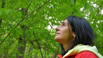 Close up young caucasian woman happy look up with joy and calmness in nature escape outdoors on hike trip .Woman wellness and recreation. Person in harmony outdoors video