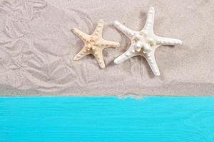 Estrellas de mar en la arena vista superior de la tabla de madera foto
