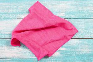 Soft pink napkin close up on wooden background photo