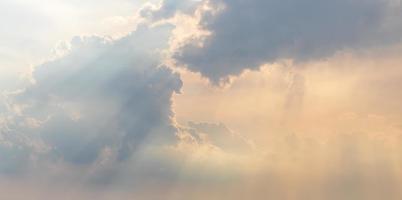 A view of clouds and sunlight shining through during the day. photo