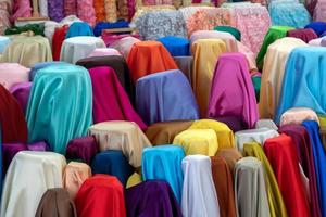 A variety of colorful fabrics covering the pillars.