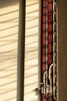 Sunlight shadow on the wall with old louver windows. photo