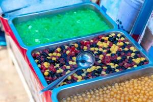 Various colorful pearl candy in the tray. photo
