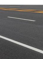 New asphalt road background with yellow lines. photo