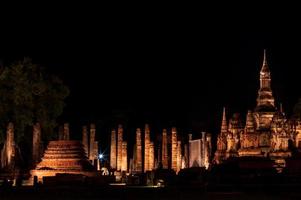 Old Buddhist temple with light in the dark. photo