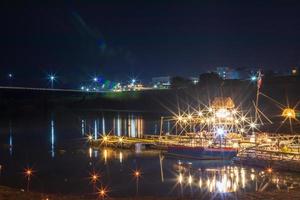 Restaurant Bamboo raft floating the river with lights at night. photo