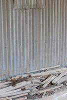 Zinc wall and old wooden remains. photo