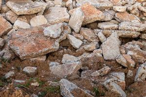Background of concrete debris piles on the ground.