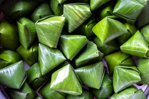 Dessert wrapped in banana leaves triangular. photo