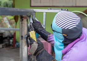 One worker wore a cloth covering the face, iron welding. photo