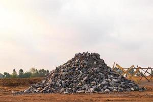 Pile of numerous granite blocks on the ground. photo