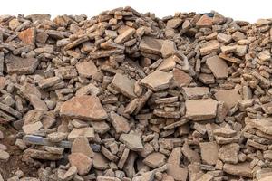 Concrete debris pile, destroyed road. photo