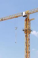 Close-up of the yellow crane with the daytime sky. photo