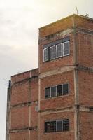 Corner building, old brick wall. photo