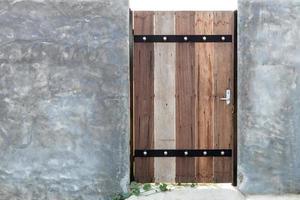 Old wooden doors installed on the cement wall. photo