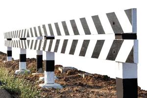 Isolated black-and-white fence that blocks the way. photo