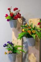 Artificial flowers in pots with interior walls. photo
