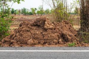 The pile of dirt near the asphalt road. photo