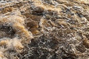 Background texture waves turbid water flowing. photo