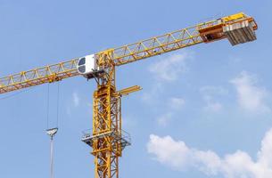 Close-up of the yellow crane with the daytime sky. photo