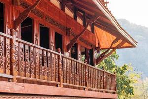 Side of the balcony of a wooden house. photo