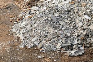 A pile of broken concrete scraps on the ground. photo