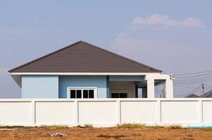 White concrete wall near the house.. photo